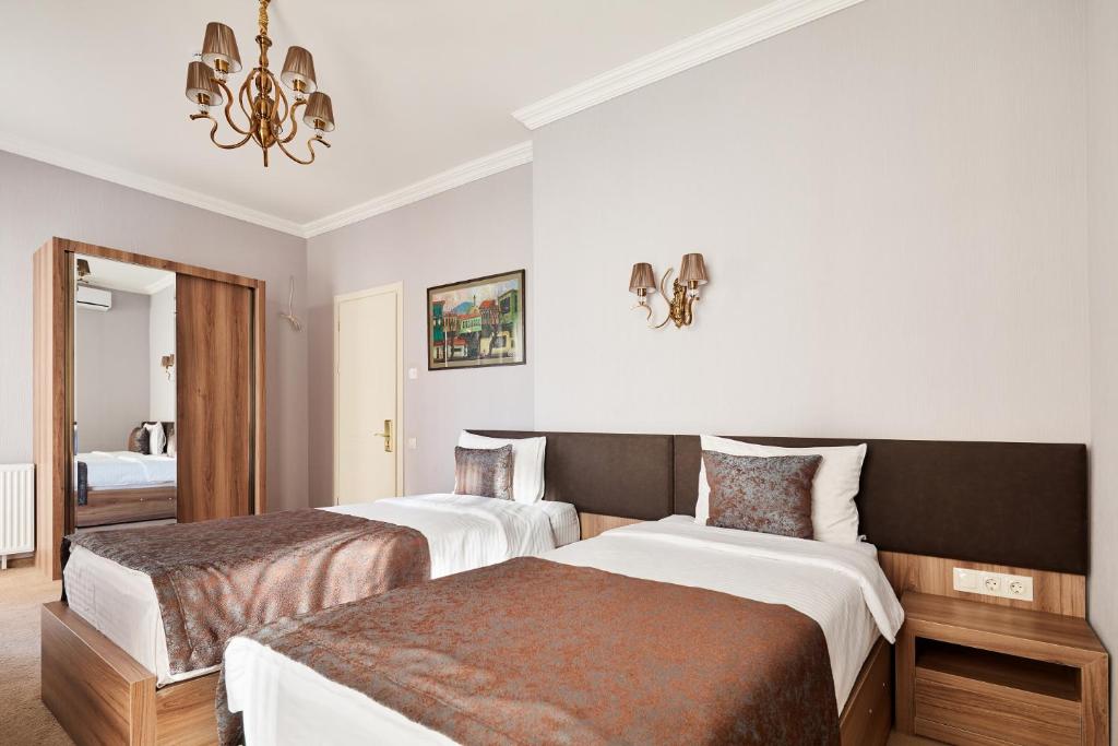 Postel nebo postele na pokoji v ubytování Hotel Pushkin