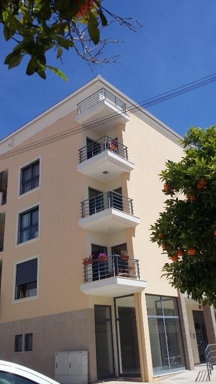 a white building with balconies on the side of it at Vacaciones en el paraíso in Lagoa