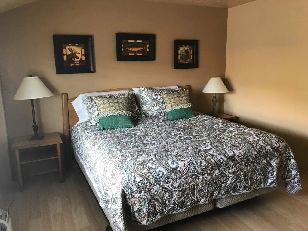 a bedroom with a bed and a lamp on the wall at Economy Guest Village in Rock Springs