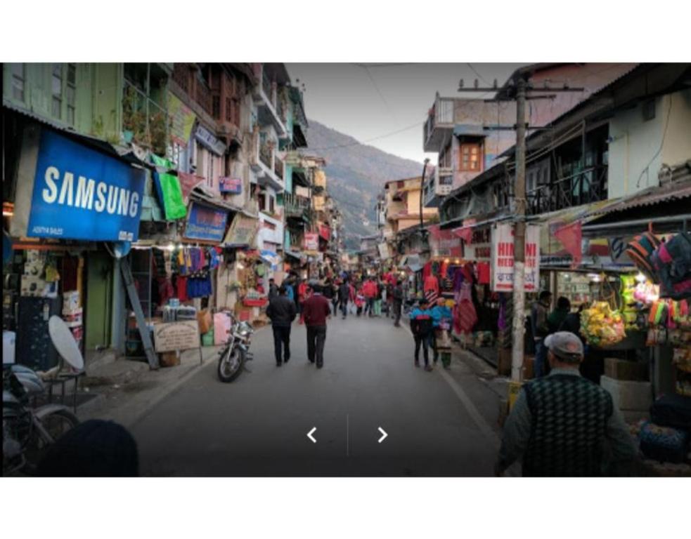 a group of people walking down a city street at Excellent Stay at Mall in Nainital