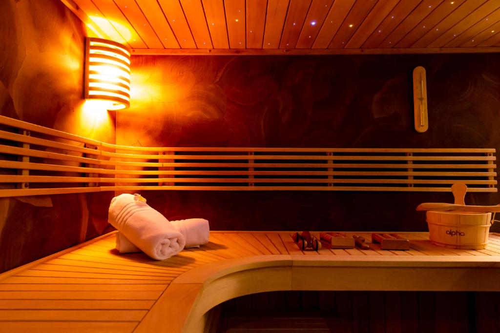 a room with a toilet paper roll sitting on a bench at Almoria Hôtel & SPA in Deauville