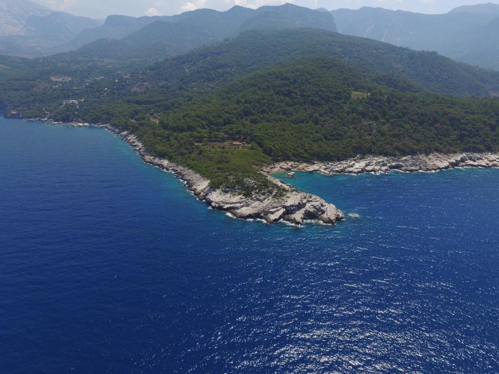 an aerial view of an island in the ocean at Rocas Roja Beach Hotel Faralya in Faralya