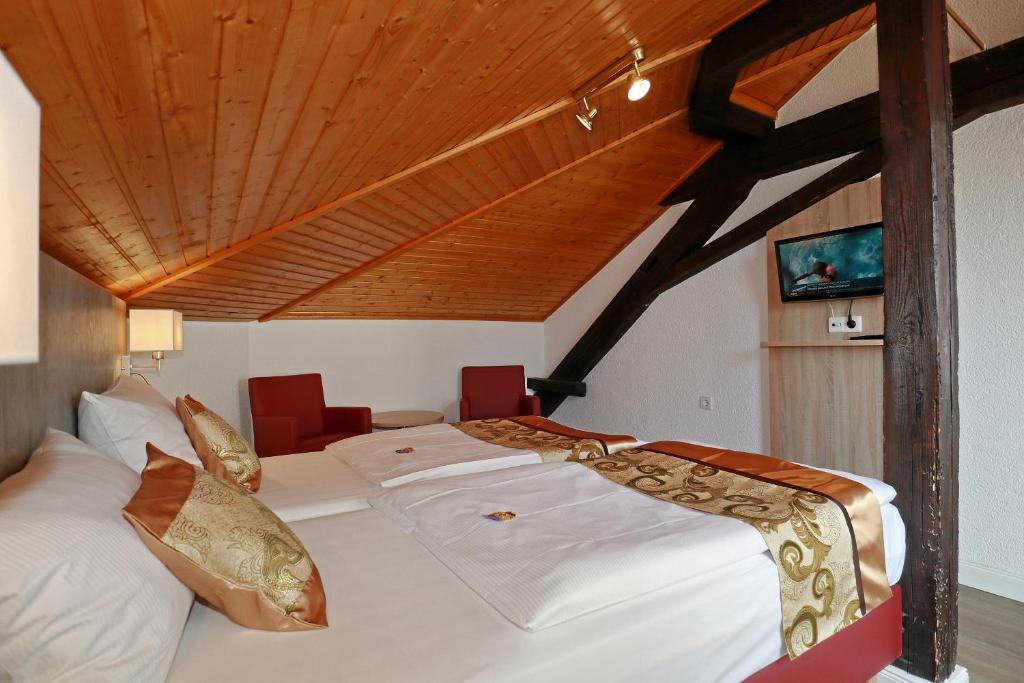 Postel nebo postele na pokoji v ubytování Hotel Danner