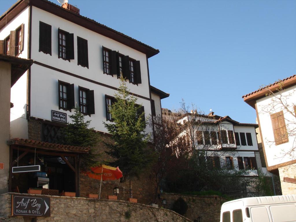 a white building with black windows on a street at Arifbey Konak Hotel in Safranbolu