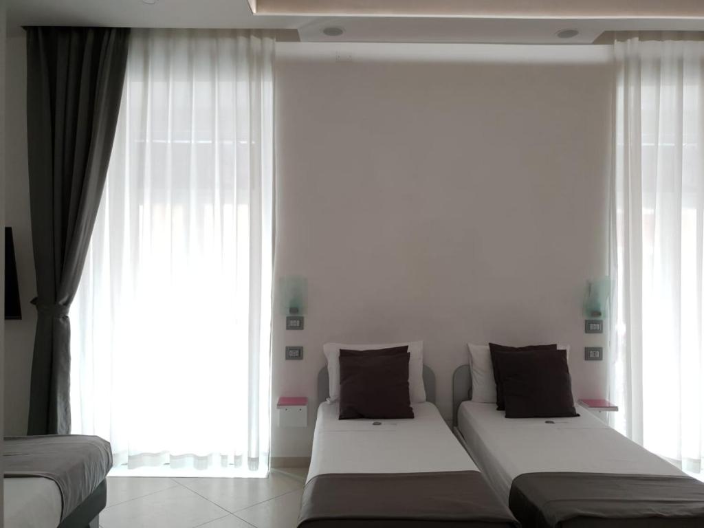 Postel nebo postele na pokoji v ubytování Hotel Nunù