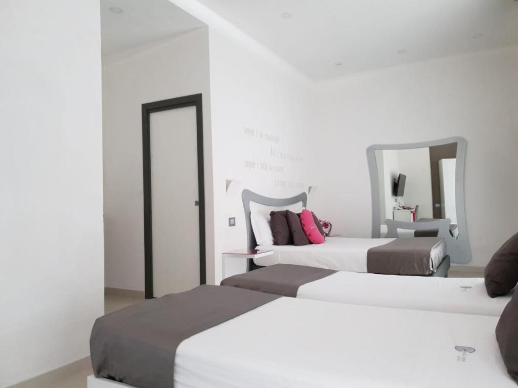 Postel nebo postele na pokoji v ubytování Hotel Nunù