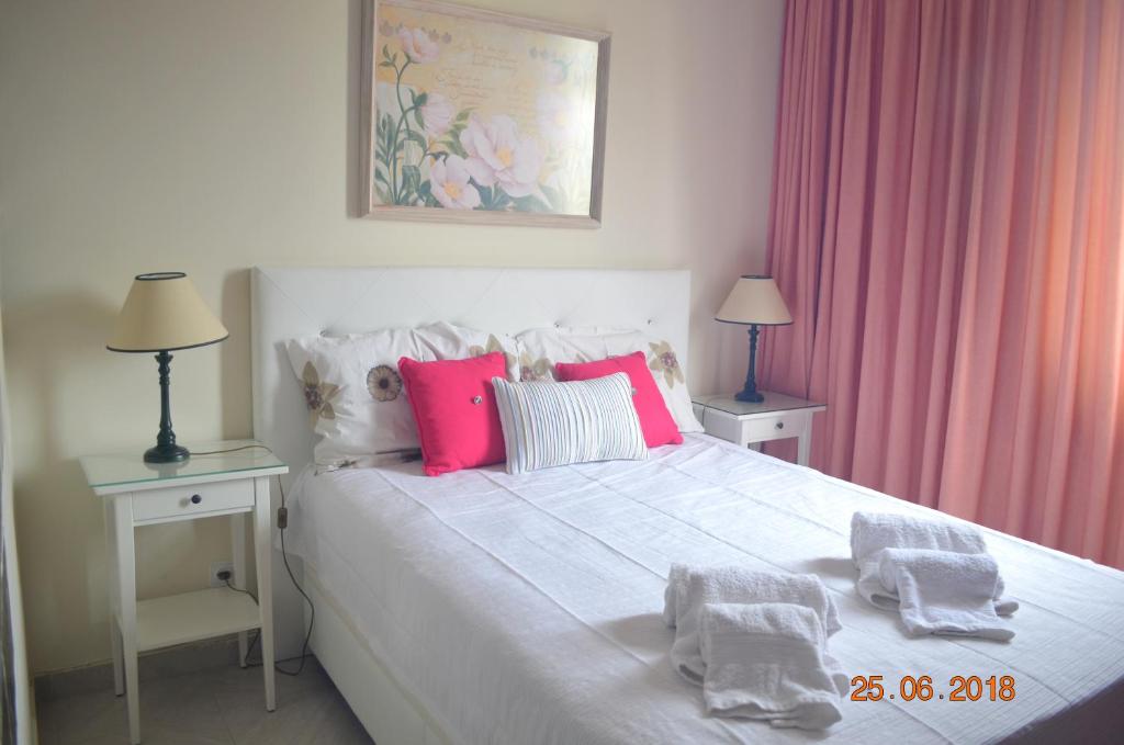 ヴィラモウラにあるVilamoura-Nautic Apartmentのベッドルーム(ピンクの枕が付いた白いベッド付)