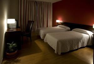 Postel nebo postele na pokoji v ubytování Hotel Millan