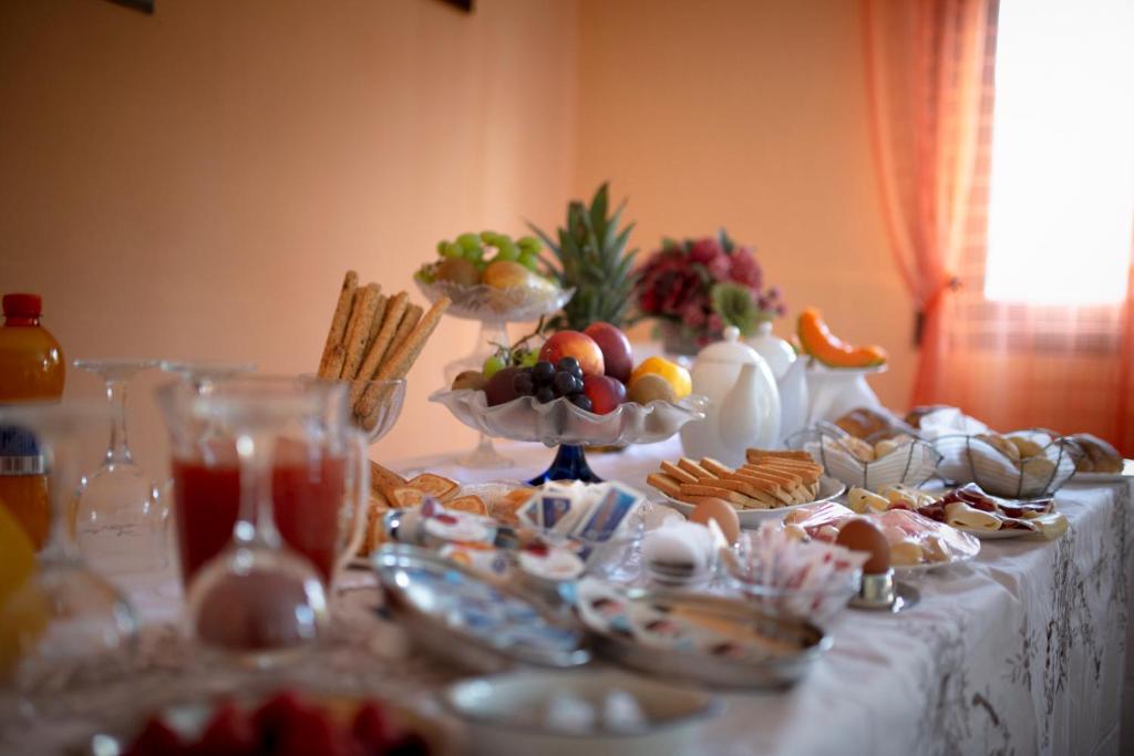 a table topped with plates of food and snacks at B&B Armonia in Enna