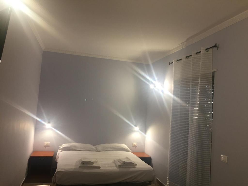 a bedroom with a bed with lights on the wall at Profumo di Zagara in Corigliano Calabro