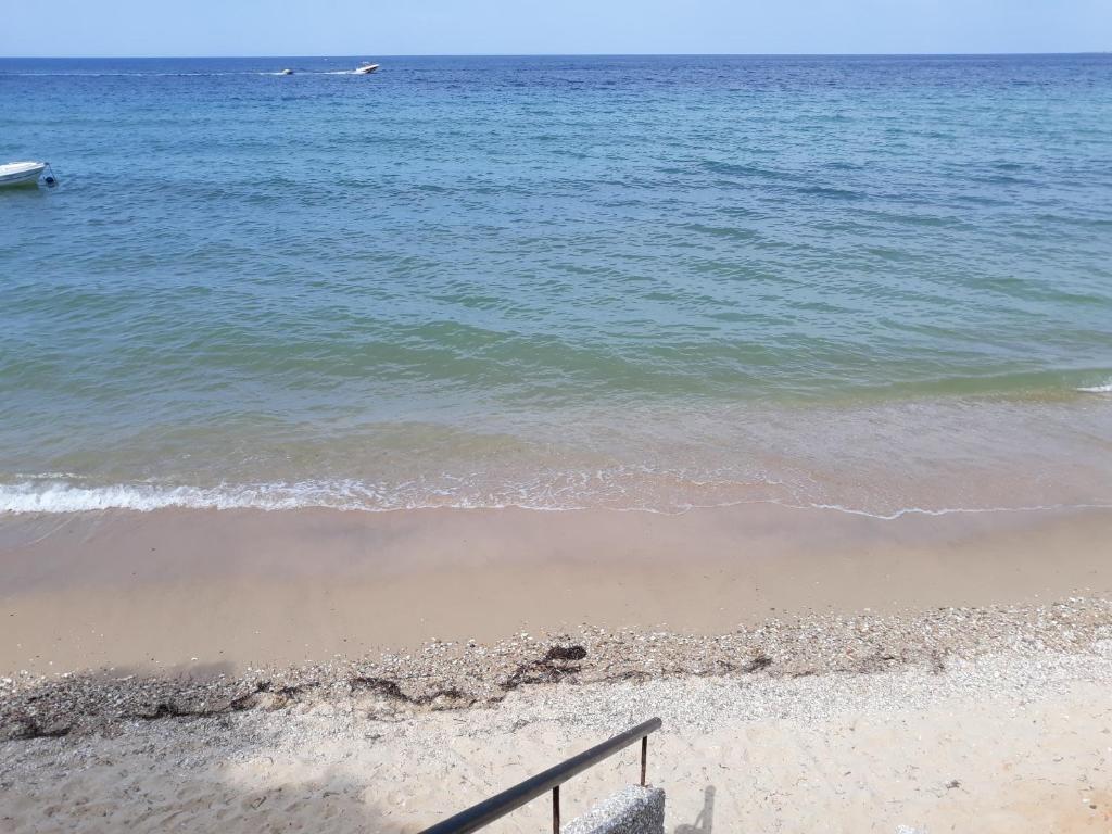 a beach with a staircase leading to the water at Ground beach studio in Nea Potidaea