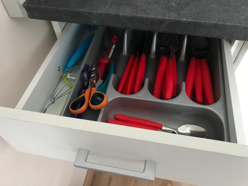 a drawer with scissors and other tools in it at Lumineux T2 Vieille ville 3 pers parking gratuit - by La Source d&#39;OrFée in Boulogne-sur-Mer