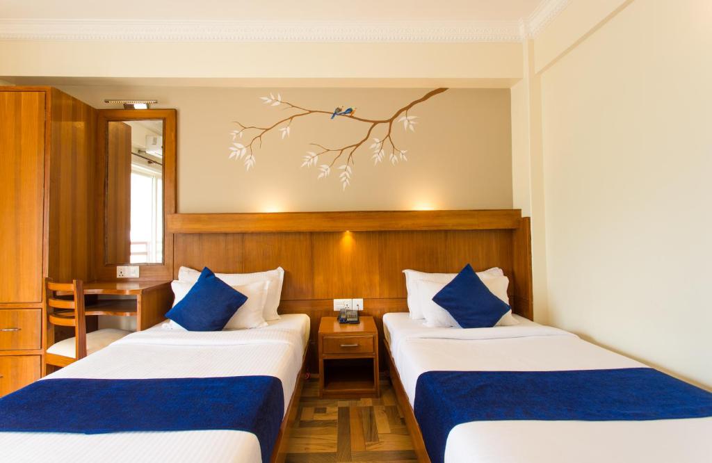 Rúm í herbergi á Hotel White Pearl