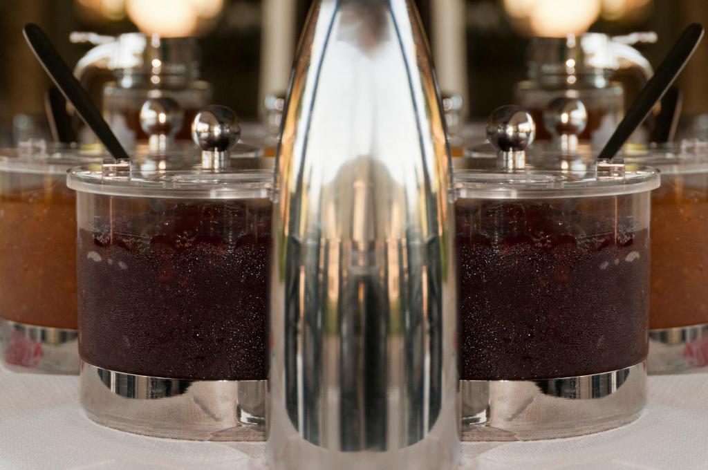 a table with three different types of drinks in jars at Riviera Perdika Hotel in Perdika