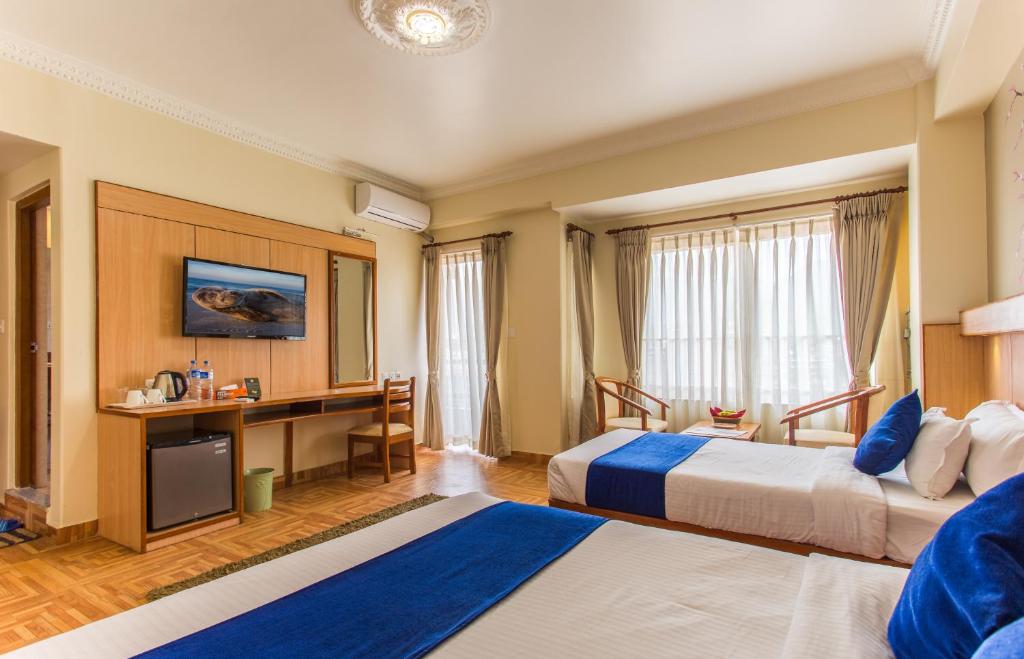 Rúm í herbergi á Hotel White Pearl