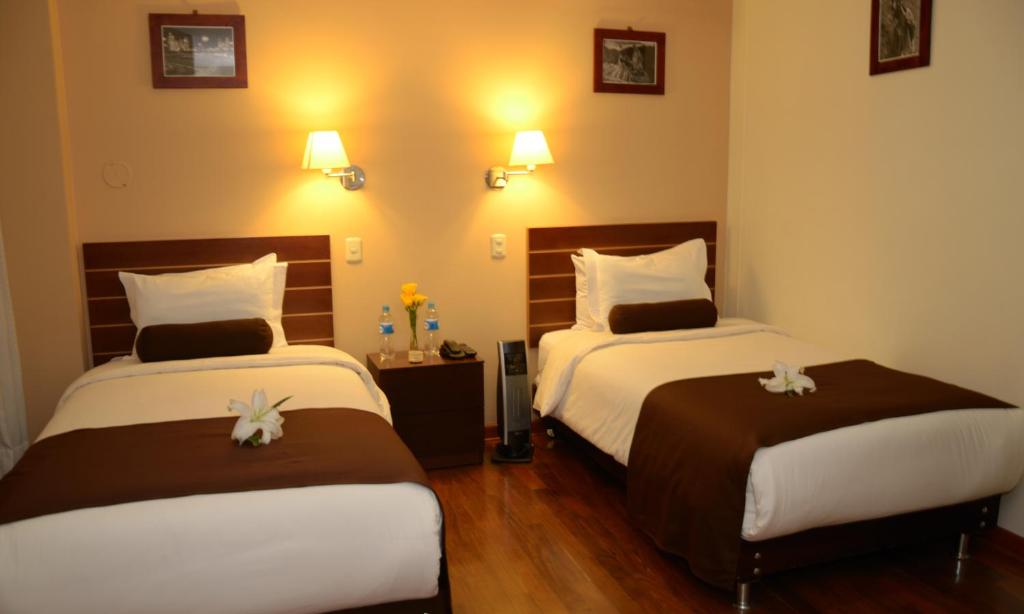 Postel nebo postele na pokoji v ubytování Kapac Inn Hotel