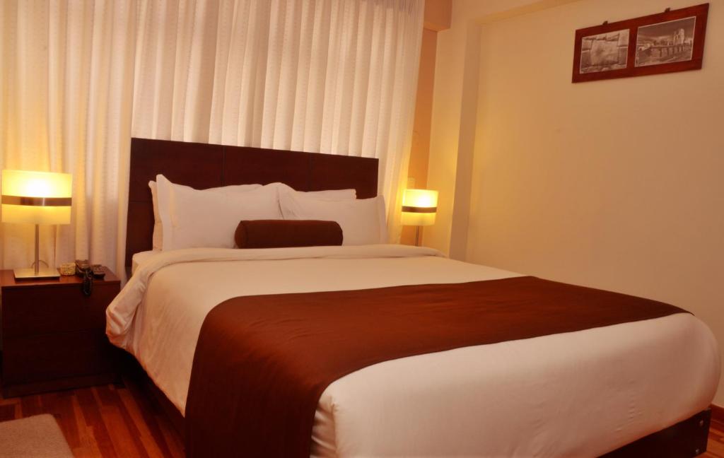 Postel nebo postele na pokoji v ubytování Kapac Inn Hotel