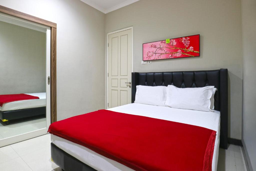 Voodi või voodid majutusasutuse Chiaro Hotel Syariah toas