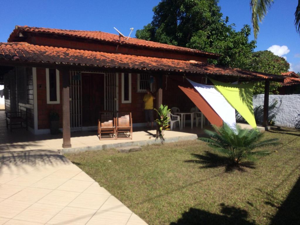 a house with awning on the side of it at Casa de Arlete in Barra do Gil