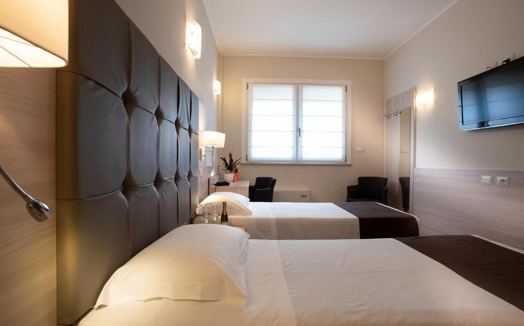 Postel nebo postele na pokoji v ubytování Hotel Montereale