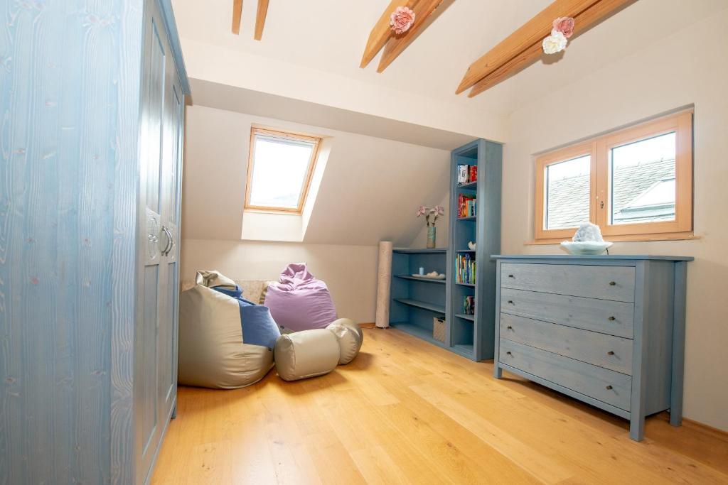 a childs bedroom with a blue dresser and a bed at House Bovecation in Bovec