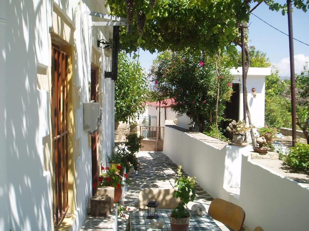 a walkway with a table and chairs next to a building at Ostria's House in Kissamos