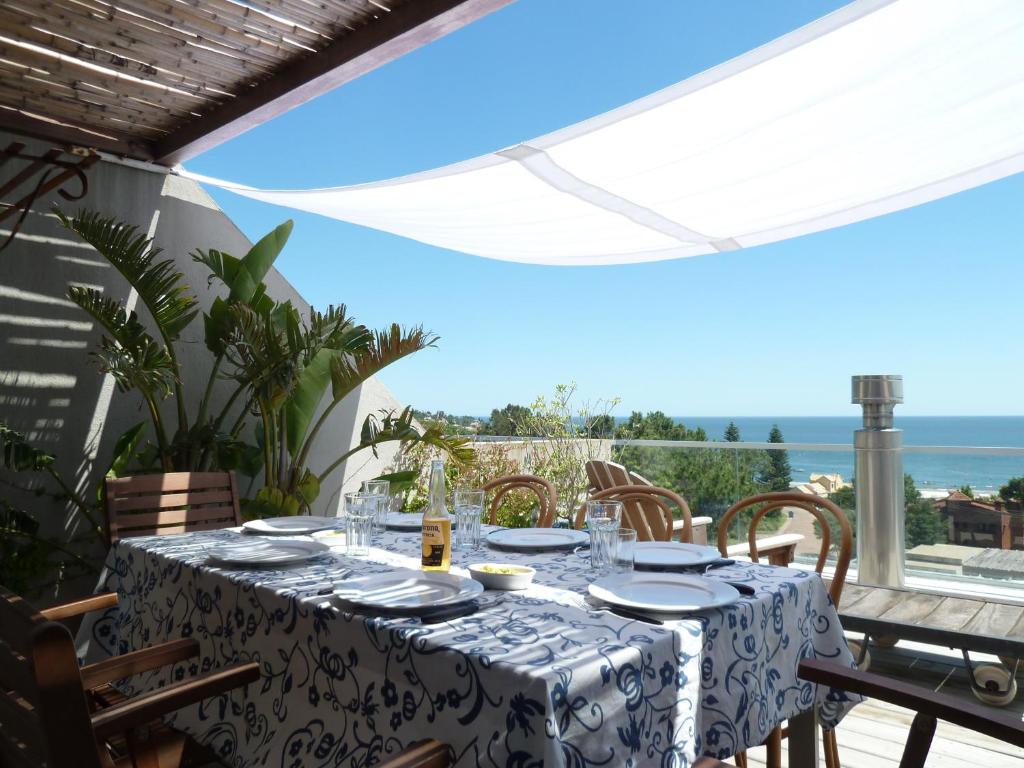 a table on a balcony with a view of the ocean at Rinconada del Mar in Punta del Este