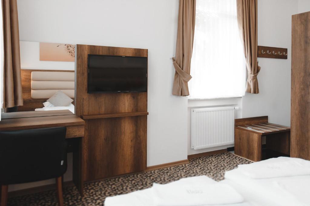 Ein Bett oder Betten in einem Zimmer der Unterkunft Hotel Castle Rastatt