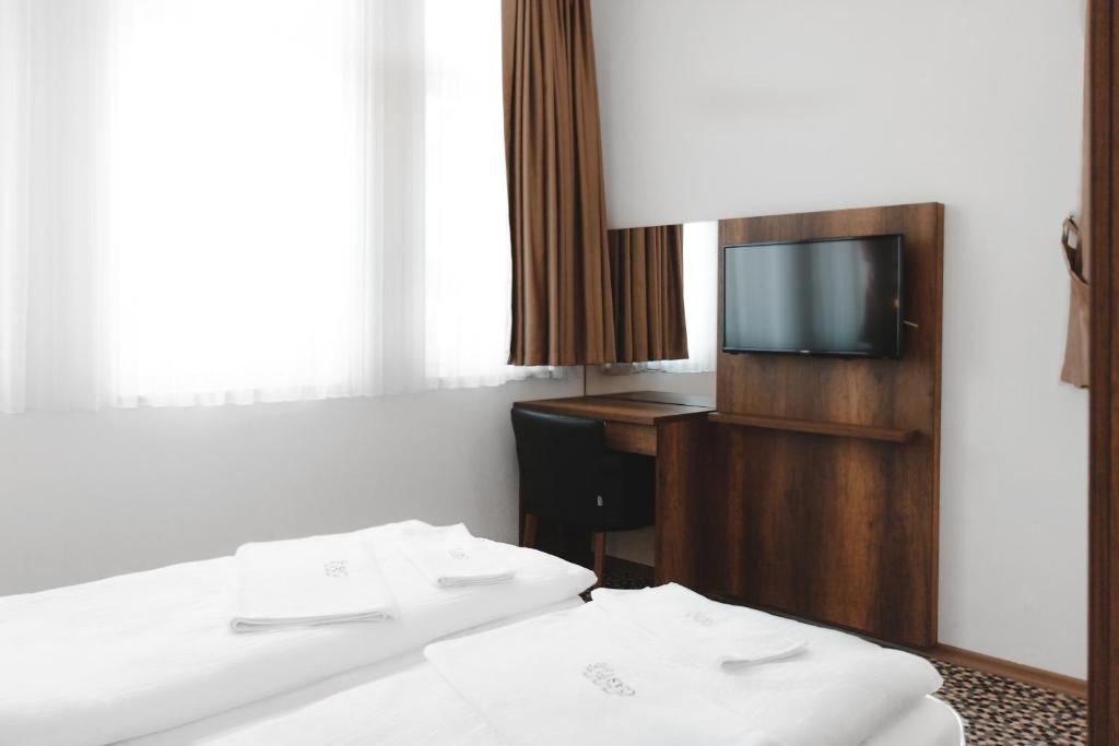 Ein Bett oder Betten in einem Zimmer der Unterkunft Hotel Castle Rastatt