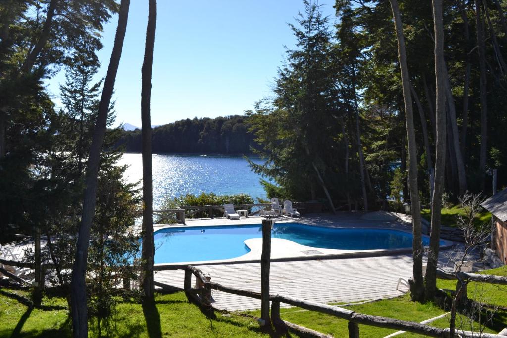 a swimming pool with a view of a lake at Punta Manzano in Villa La Angostura