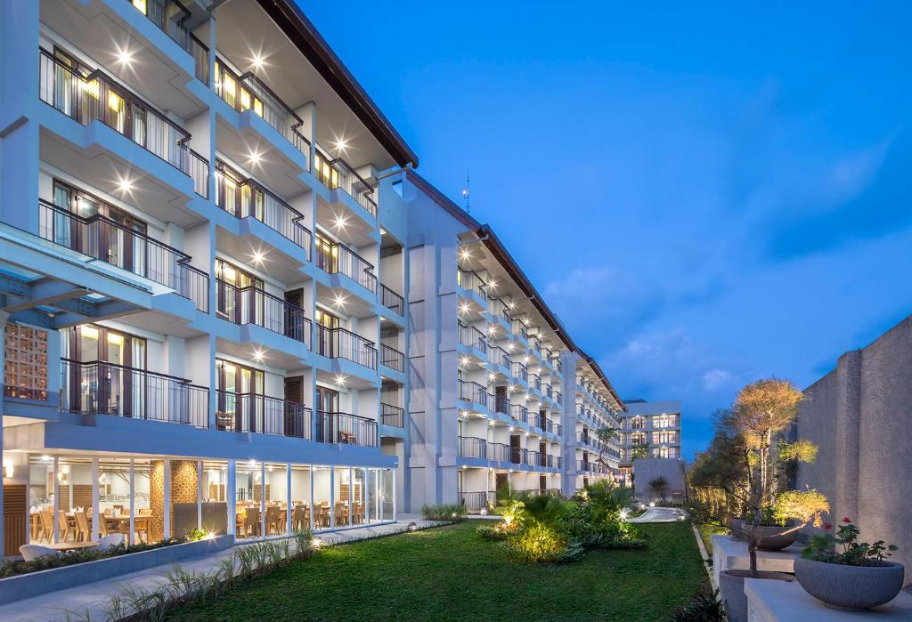 an exterior view of a building at night at Eastin Ashta Resort Canggu in Canggu
