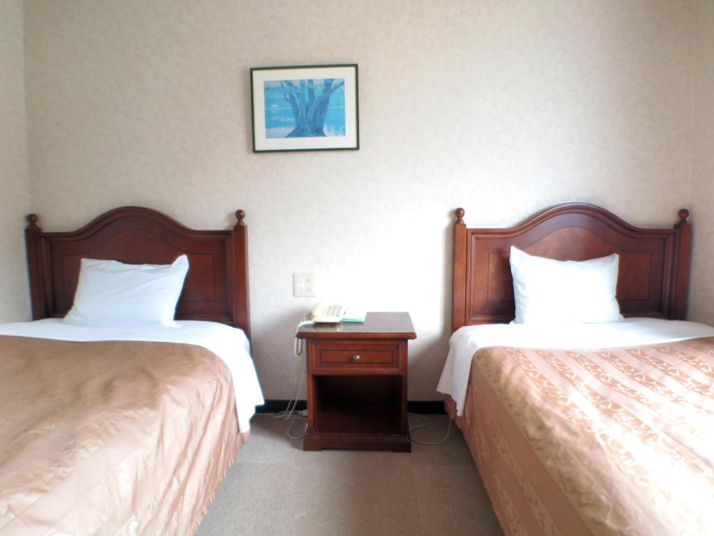 Postel nebo postele na pokoji v ubytování Aiwa no Mori Hotel