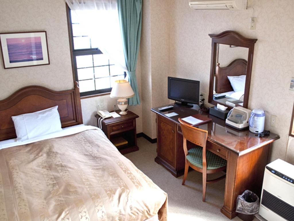 Postel nebo postele na pokoji v ubytování Aiwa no Mori Hotel
