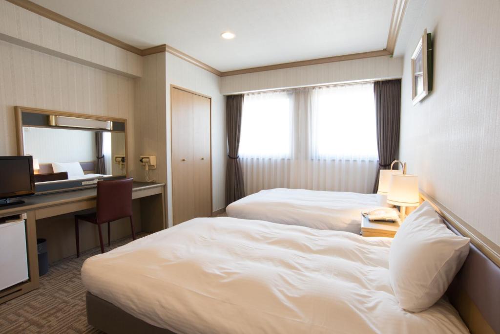 Postel nebo postele na pokoji v ubytování Hotel Suncrest