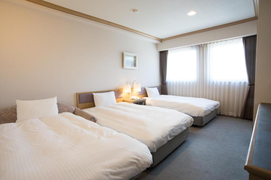 Postel nebo postele na pokoji v ubytování Hotel Suncrest