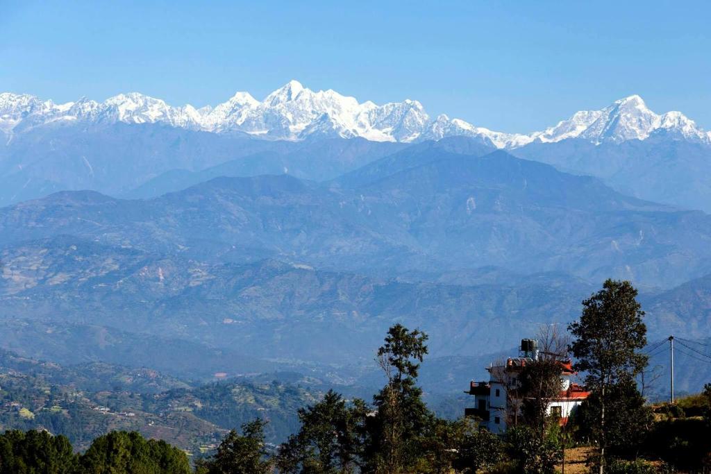 a mountain range with snow capped mountains in the distance at Tashidelek Guest Lodge & House in Dhulikhel