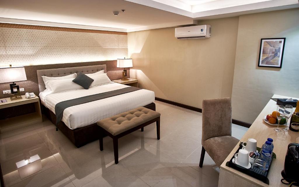 Postel nebo postele na pokoji v ubytování J7 Hotel