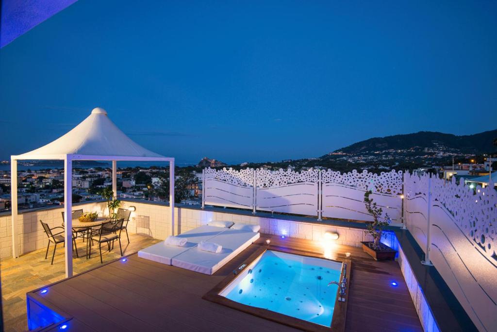 a balcony with a pool and a table and a tent at Hotel Terme President in Ischia