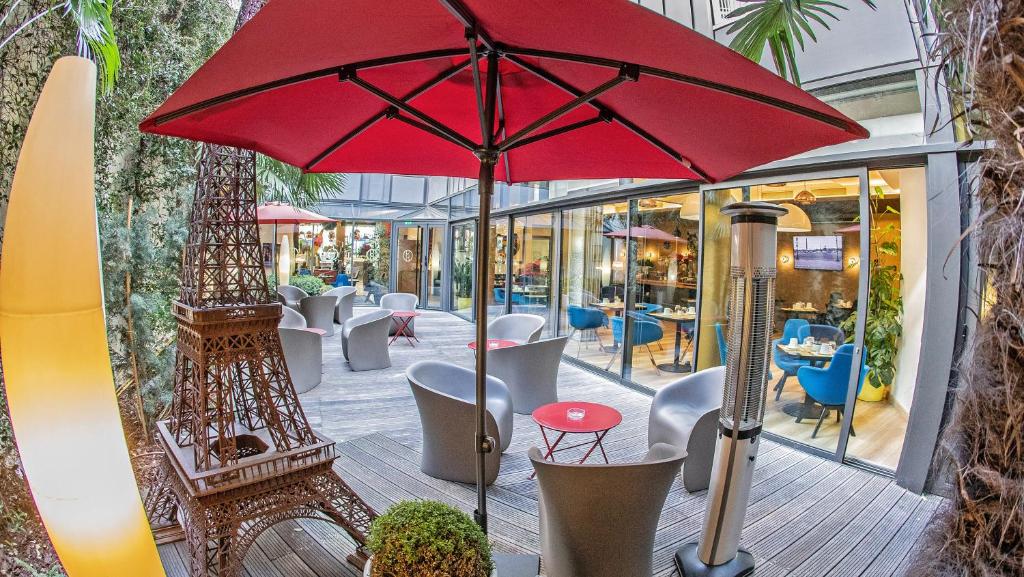 a red umbrella sitting on top of a patio at Hôtel Hor Europe in Paris