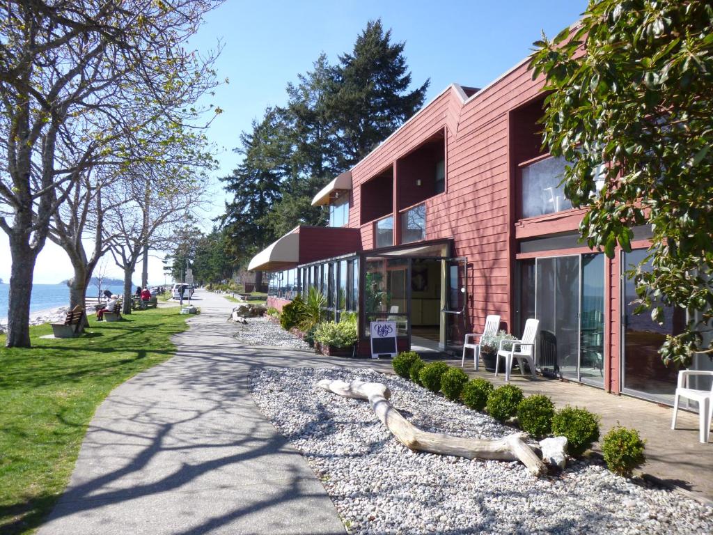 a brick building with a bench and a sidewalk at Driftwood Inn in Sechelt