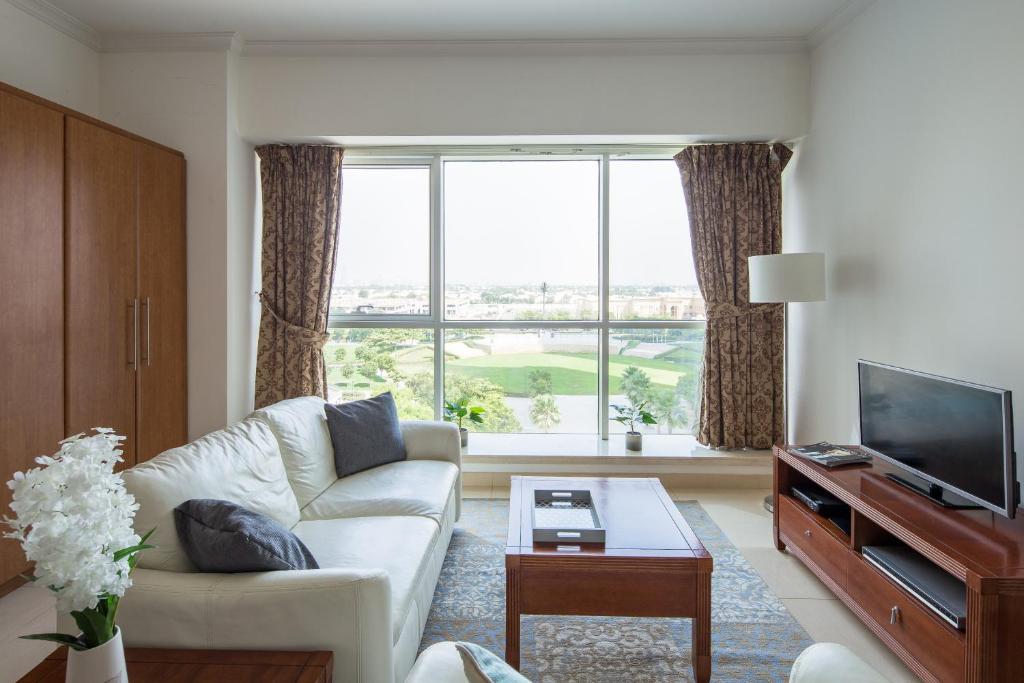 a living room with a couch and a large window at Frank Porter - Saba 3 in Dubai