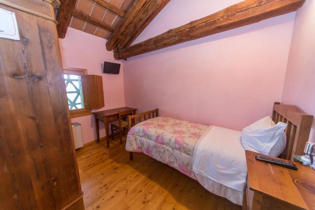 Postel nebo postele na pokoji v ubytování Agriturismo Cjasal di Pition