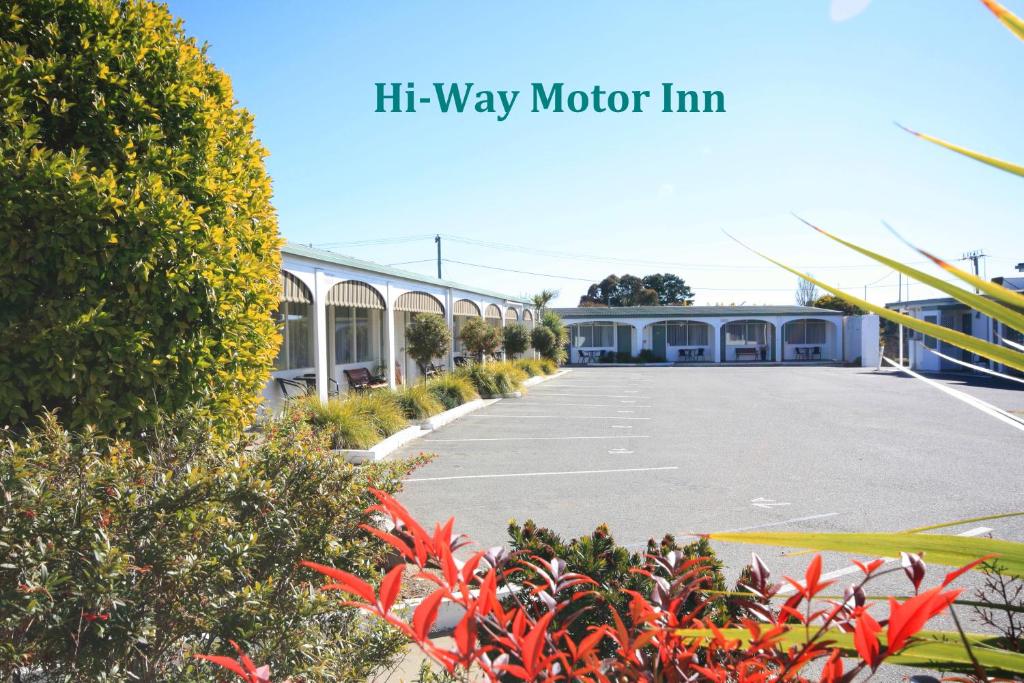 a large building with a sign on the side of it at Hi Way Motor Inn in Yass