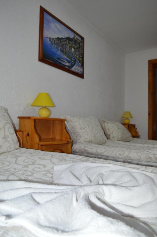 A bed or beds in a room at Baba Dora Guesthouse