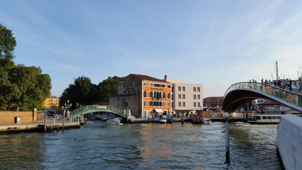 uma vista para um rio com uma ponte e edifícios em Hotel Santa Chiara em Veneza