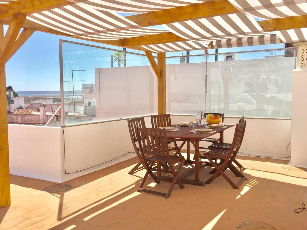 a table and chairs on a balcony with a view at Alvor Terrace Villa in Alvor