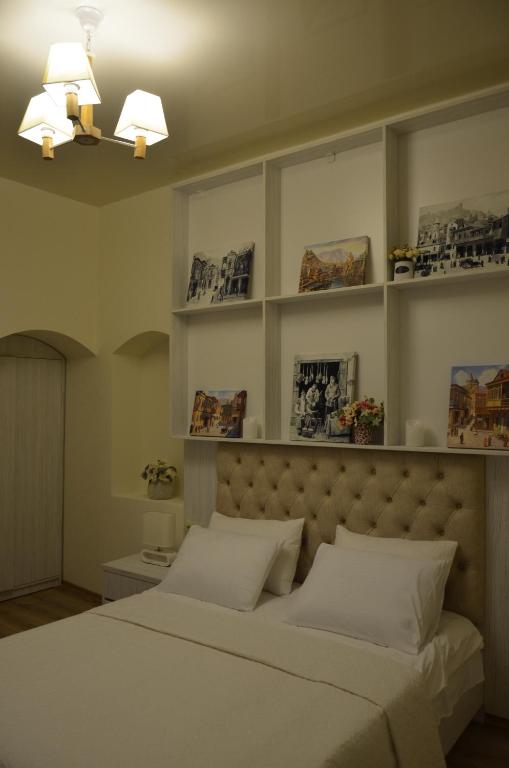 Postel nebo postele na pokoji v ubytování Hotel Griboedov