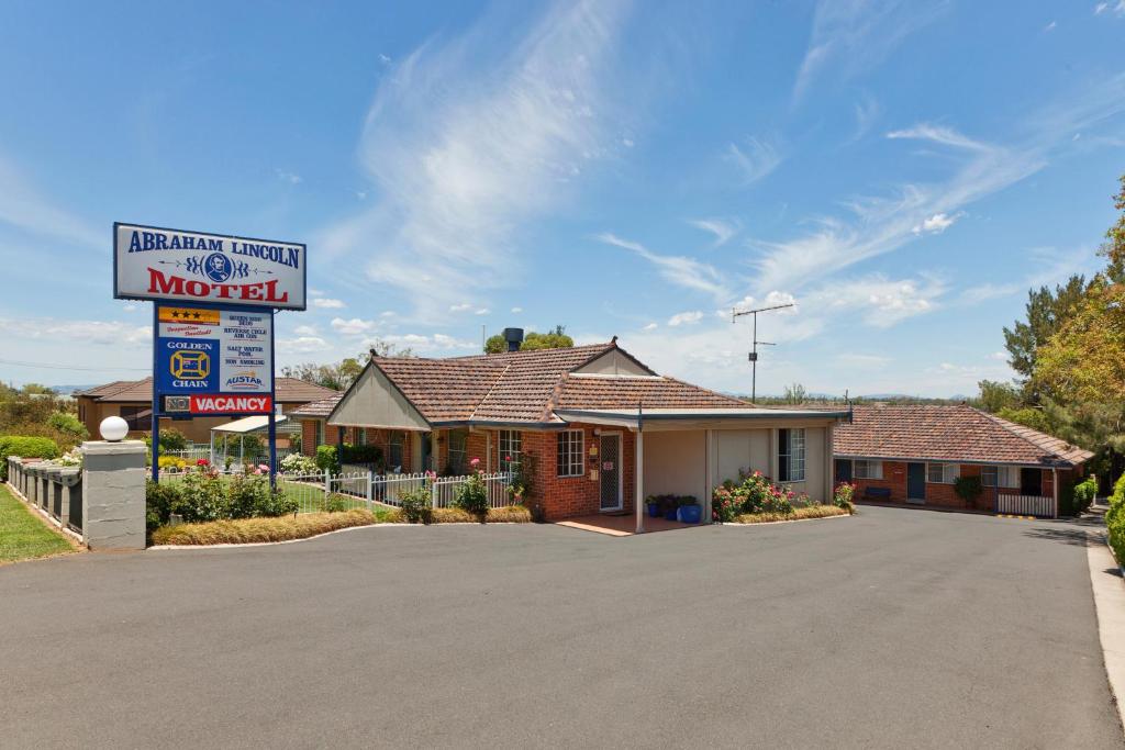 un benzinaio con un cartello davanti di Abraham Lincoln Motel a Tamworth