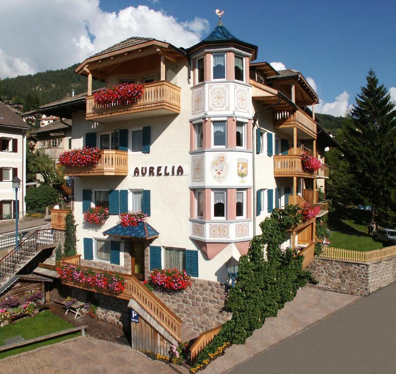 a building with a clock on the side of it at Villa Aurelia in Ortisei