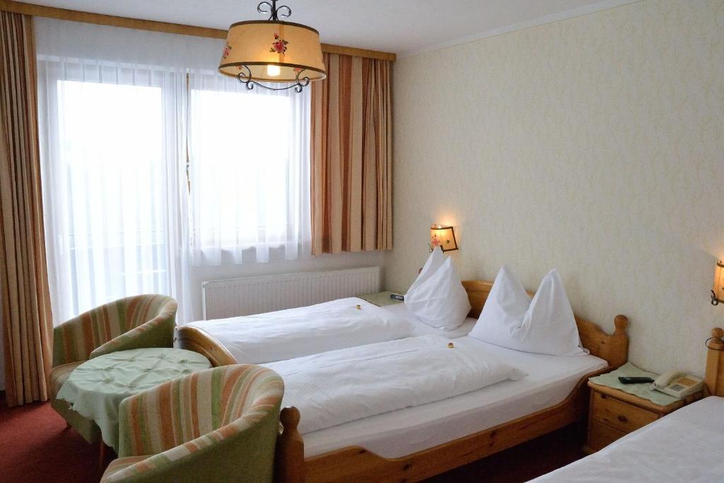Postel nebo postele na pokoji v ubytování Hotel Tischlbergerhof